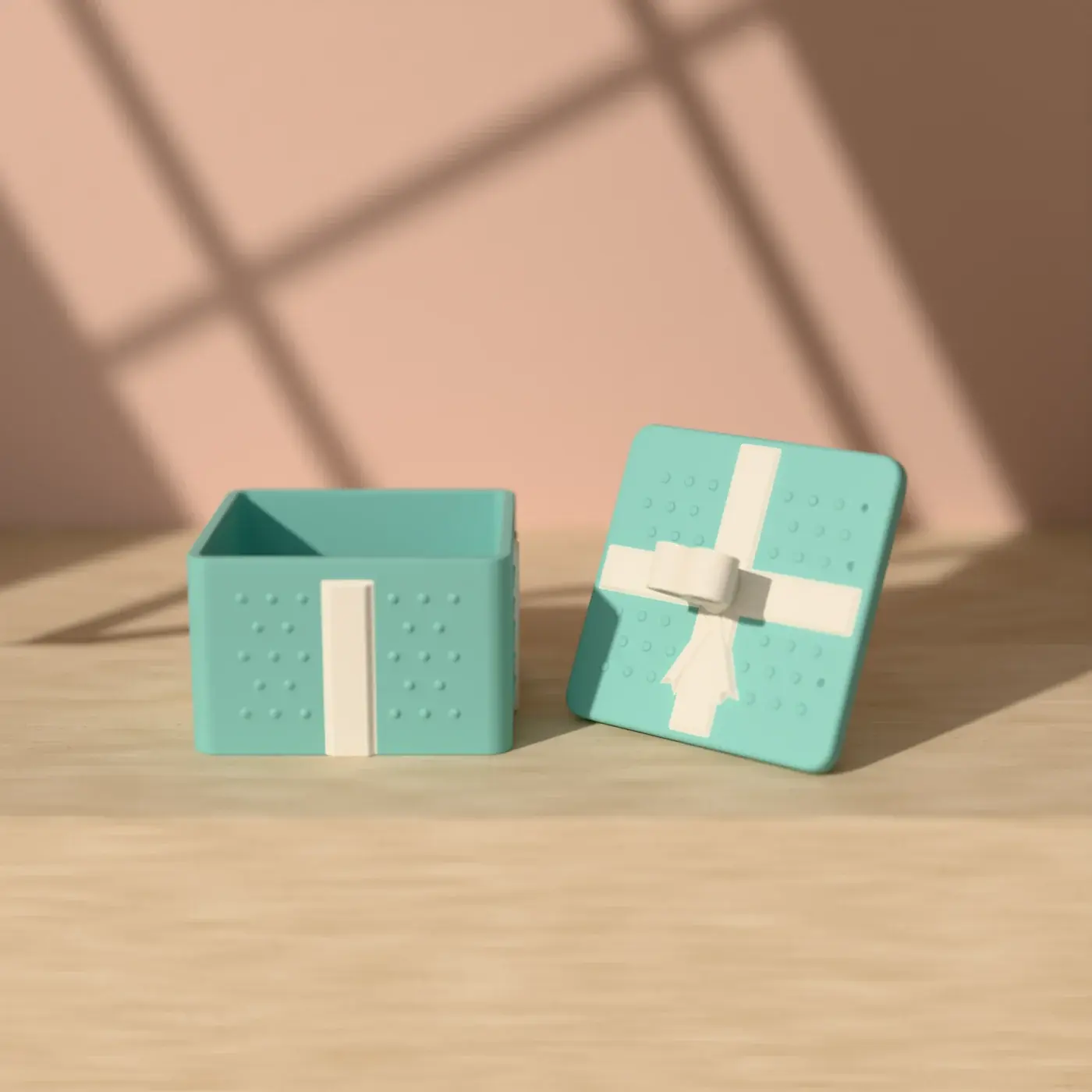 The present box, open with its lid beside it: a robin’s-egg-blue polka-dot box with a white ribbon down each side and a lid with a white ribbon cross, tails and a two-loop bow.