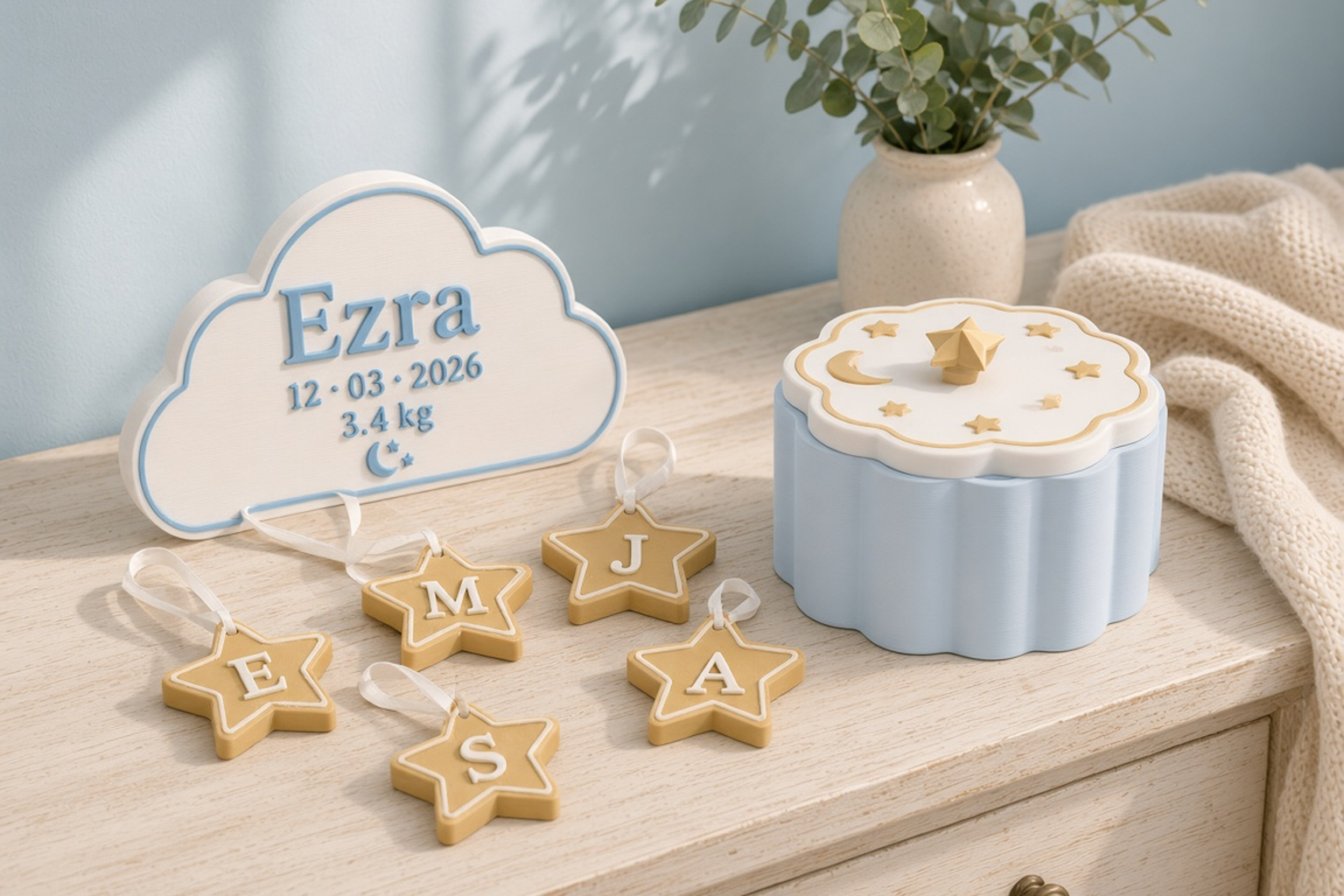 Baby shower collection with a baby-blue cloud box with a gold star knob, a white Ezra cloud announcement plaque and gold star keepsakes